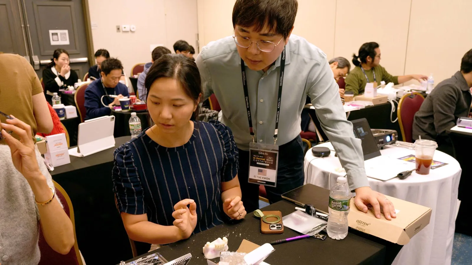 Dr. Kwon guiding a dentist through a hands-on implant exercise